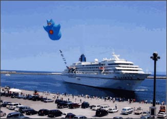 People welcoming a cruise ship entering into harbor.