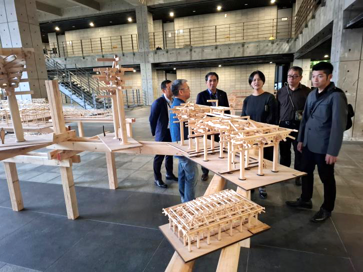 頁践大學校内に展示されている、木造建築模型の説明を受ける